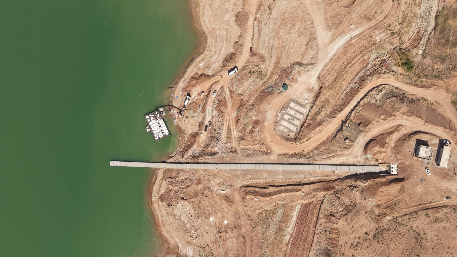 Aerial view of the Khanke intake causeway reaching out across the lake